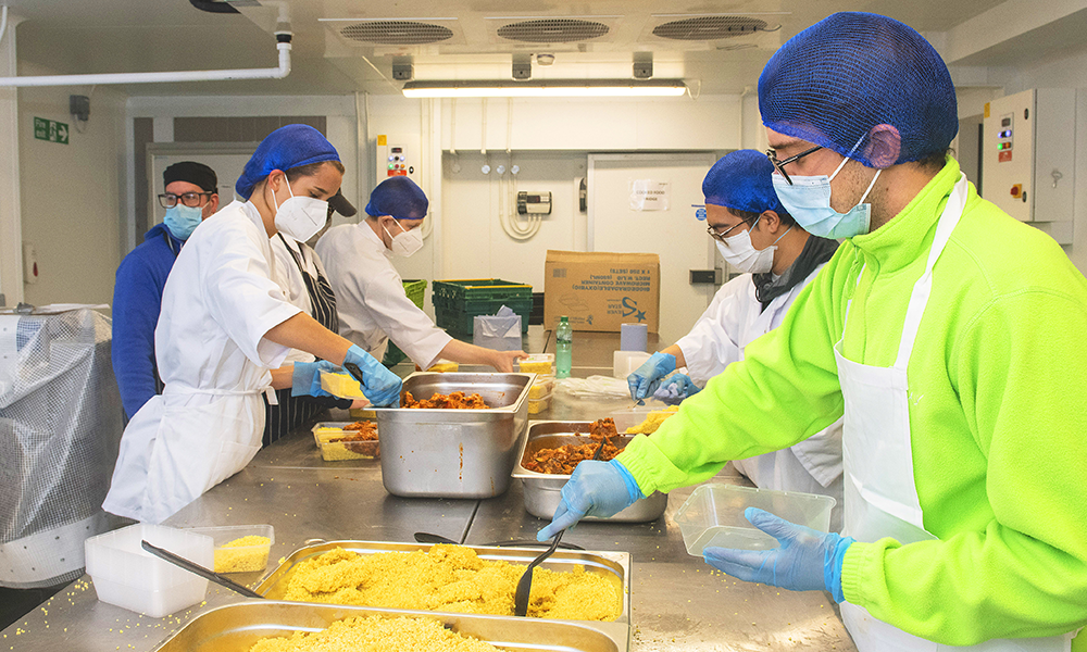 Staff and volunteers portion up meals at Felix's Kitchen