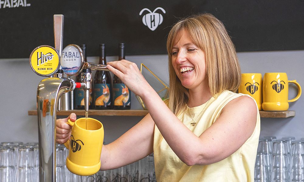 Hannah pours a Phoebee stein of beer