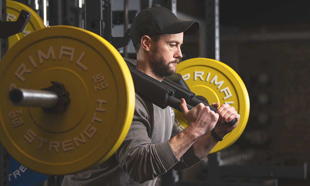 Tim demonstrates a squat at the club