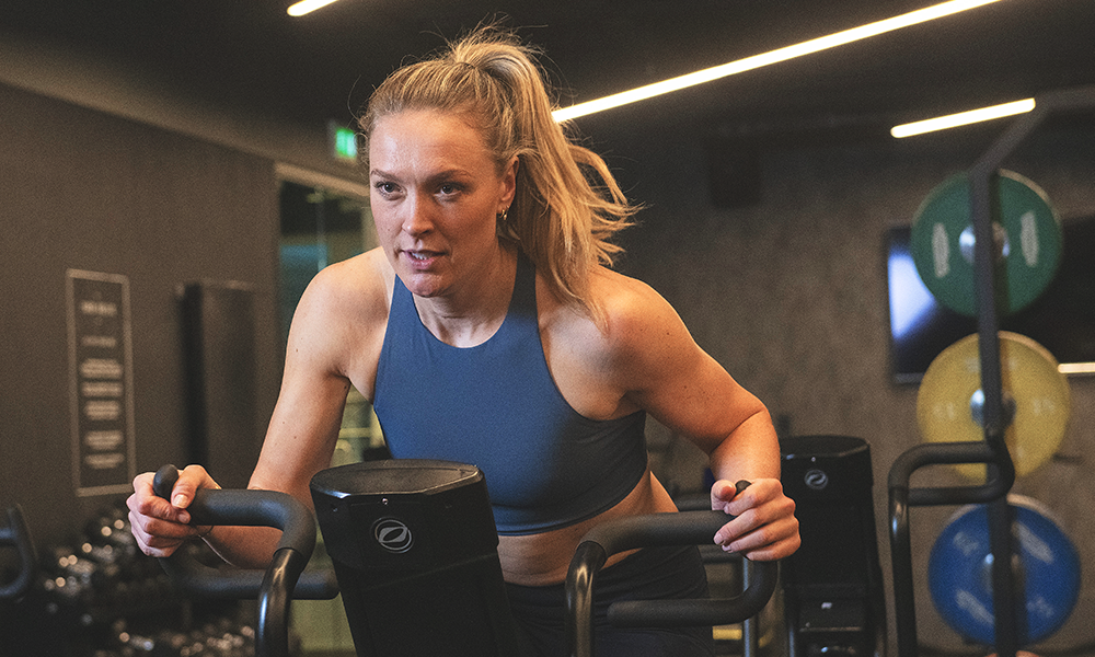 Kate takes on the air bike on the gym floor