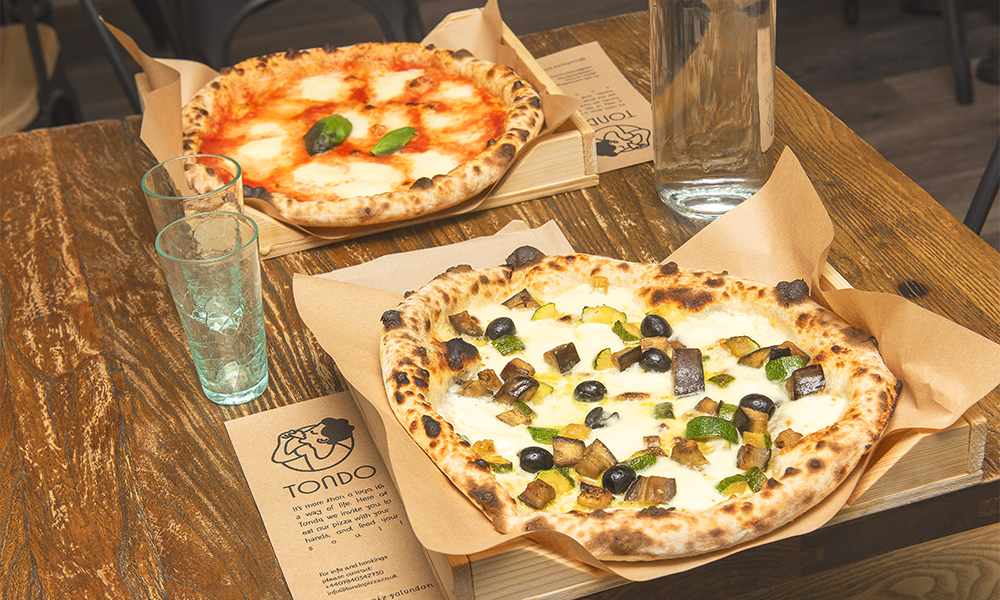 Pizzas are served on wooden trays