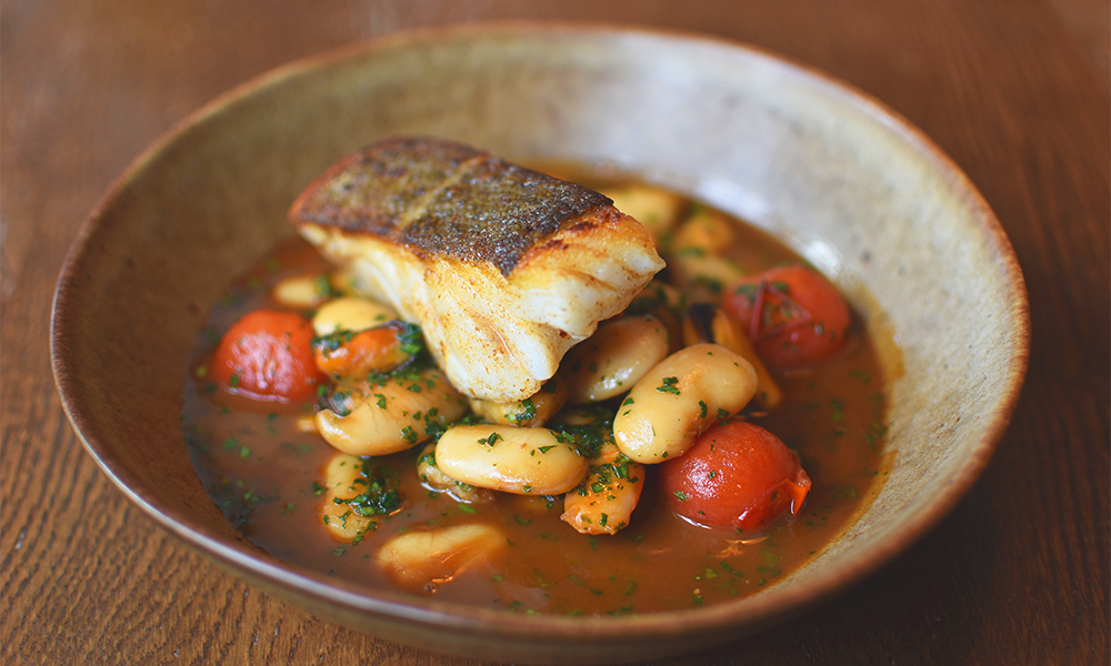 Pan-roasted cod with white bean, tomato, mussel and prawn stew