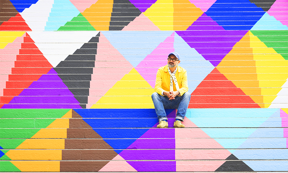 Lothar sits surrounded by the triangles of his piece Upbeat