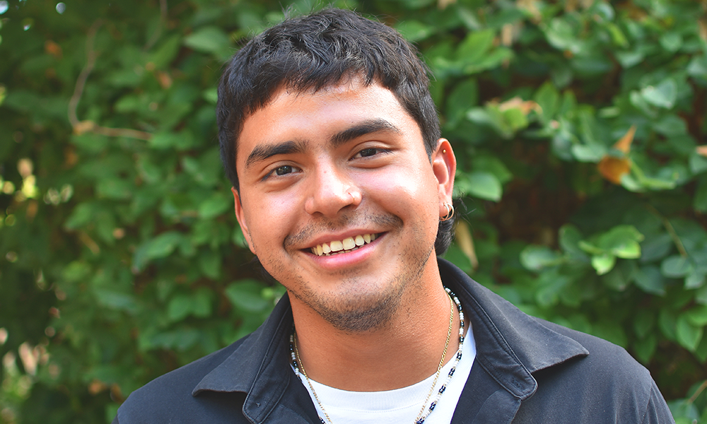 Image shows Geovanny Rodriguez, a young dark-haired man with pierced ears wearing a black shirt and white T-shirt
Geovanny studied at New City College between ages 14 and 18