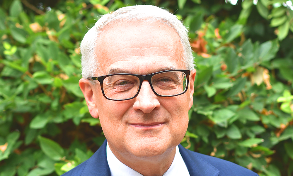 Image shows Gerry McDonald, a white-haired man with black-rimmed spectacles in a blue suit and white shirt
Gerry is group principal and CEO of New City College