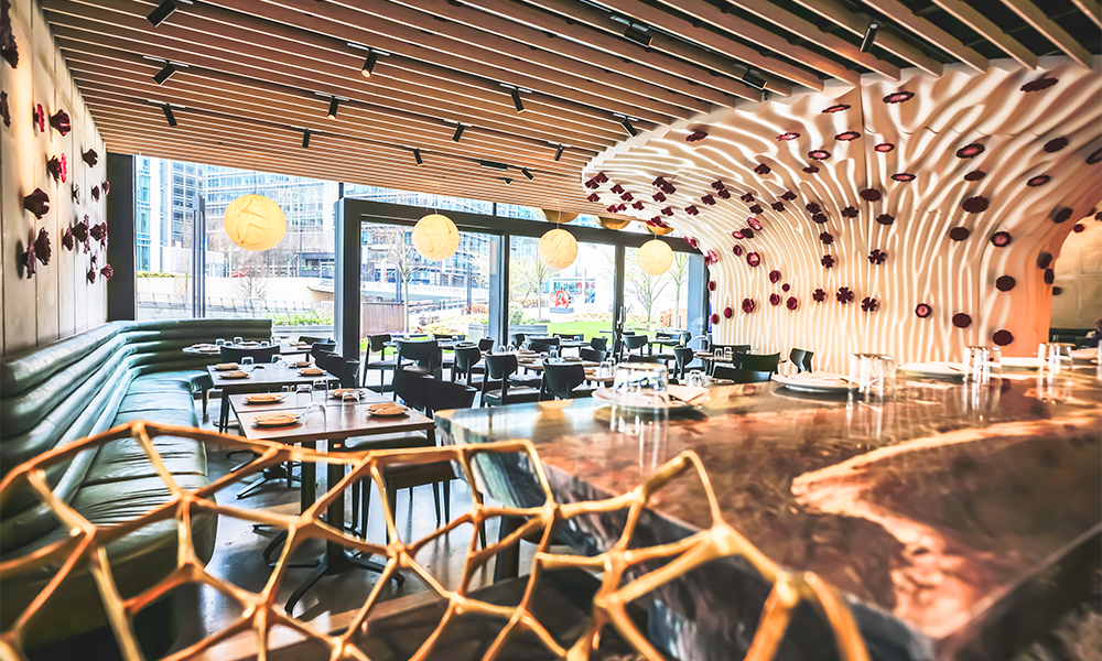 An image of the interior of Roe restaurant in Canary Wharf featuring a large sculpture that looks like a coral in white and red hues
