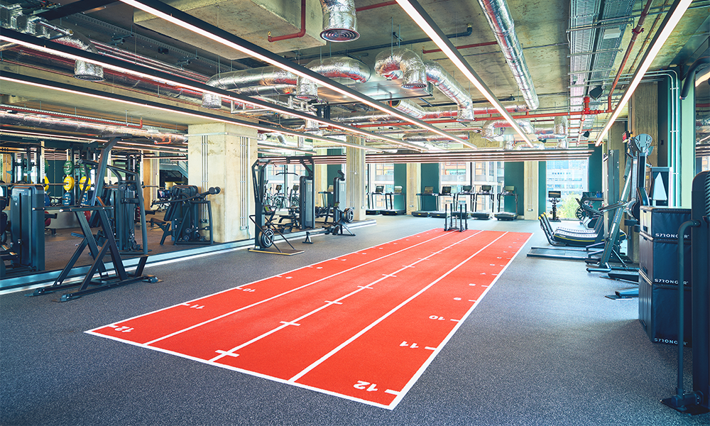 Image shows the new club's main gym area including a bright red track for training on
