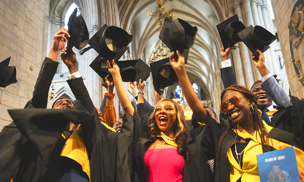University Of Sunderland In London students celebrate by throwing their mortar boards in the air at Southwark Cathedral