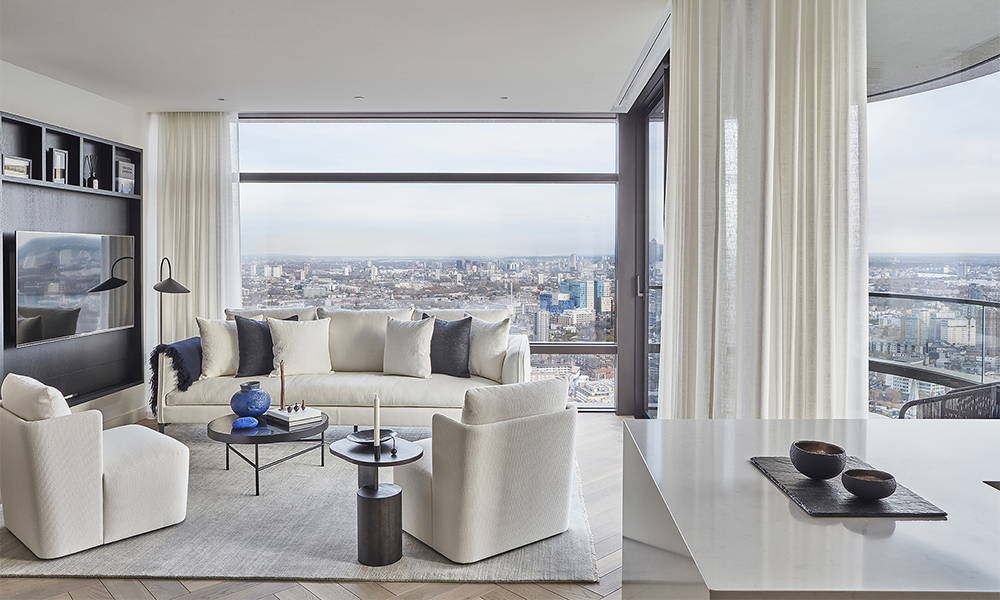 Image shows a living room with curved glazing offering views across London