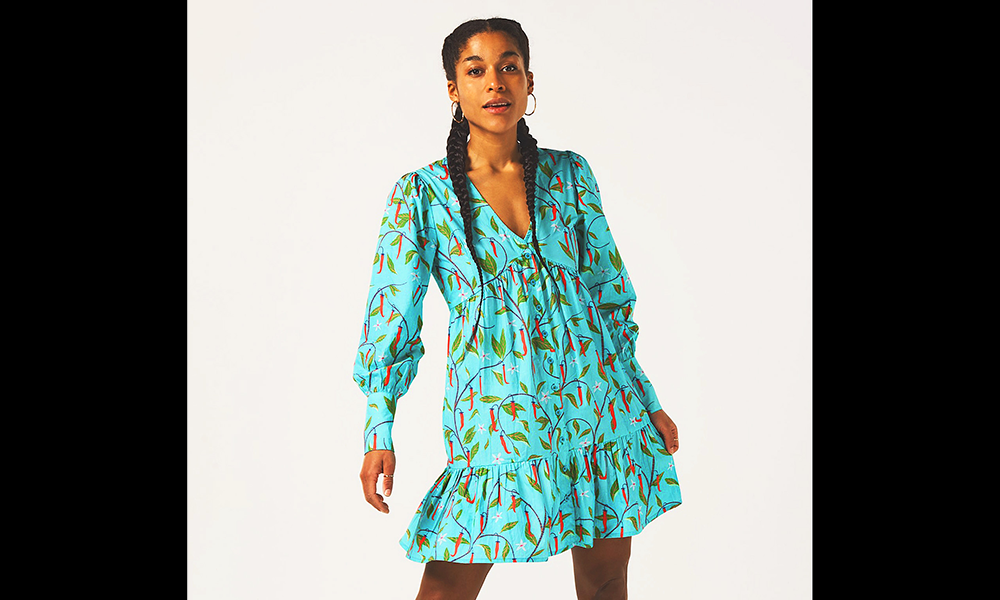 Image shows a turquoise dress with a chilli plant print from The Paradise Collection