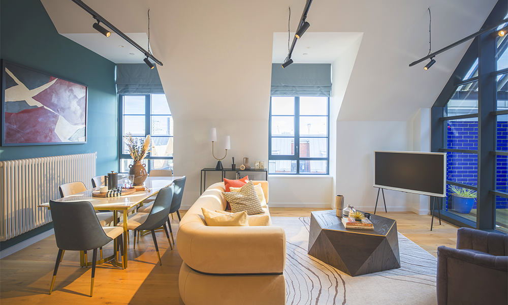 The living area of a loft apartment at Goodluck Hope features open-plan design and a private terrace