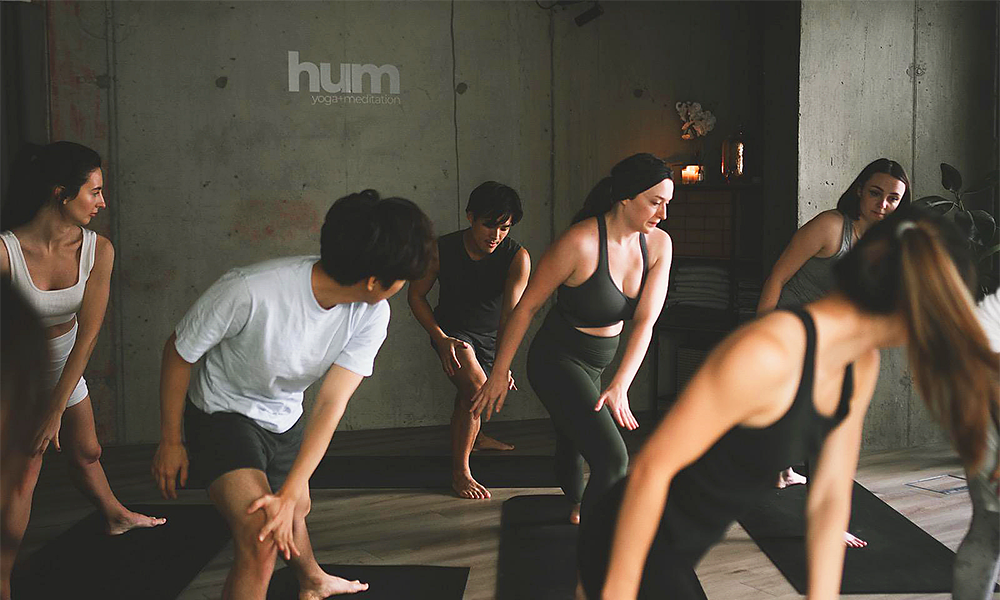 People adopt Yoga poses in Hum's London City Island studio
