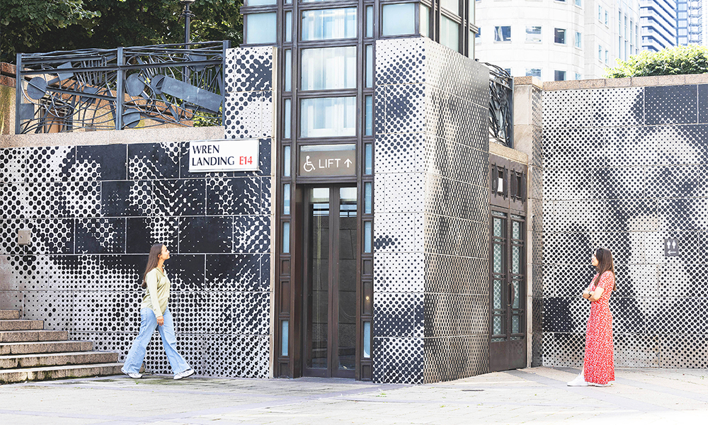 Two women look at Henry's artwork at Canary Wharf's Wren Landing