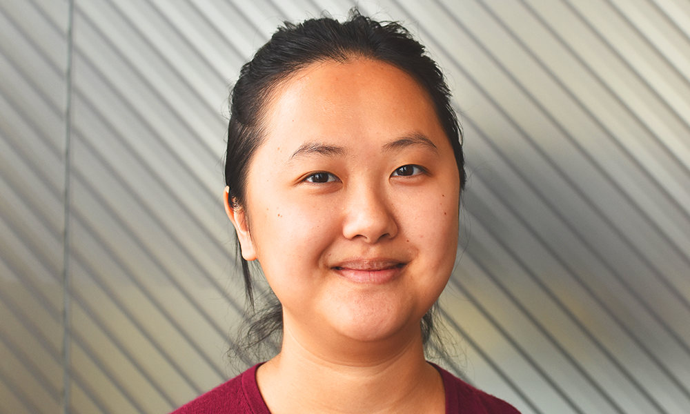 
Image shows PhD student and teaching assistant at UCL School Of Management, Velvetina Lim, weaing a red jumper