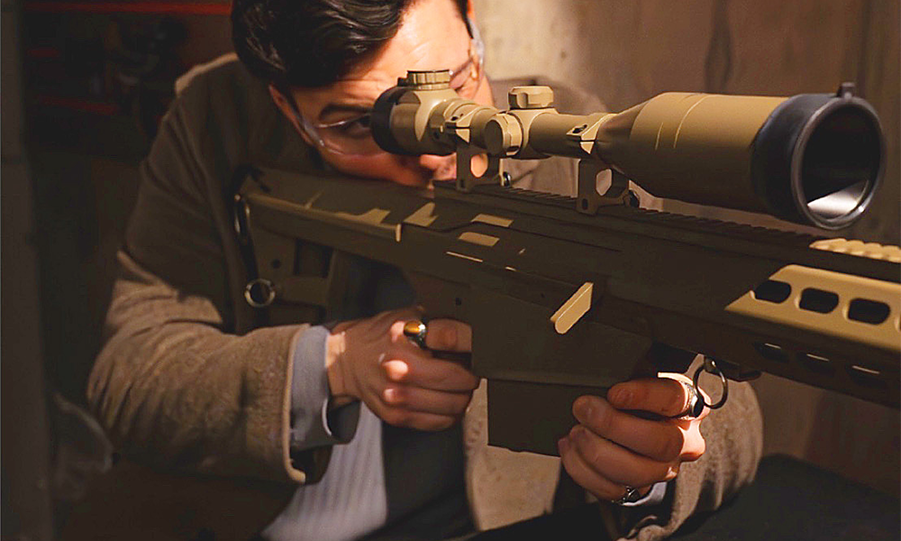 A man in a brown coat aims a large brown sniper rifle with a huge scope at targets