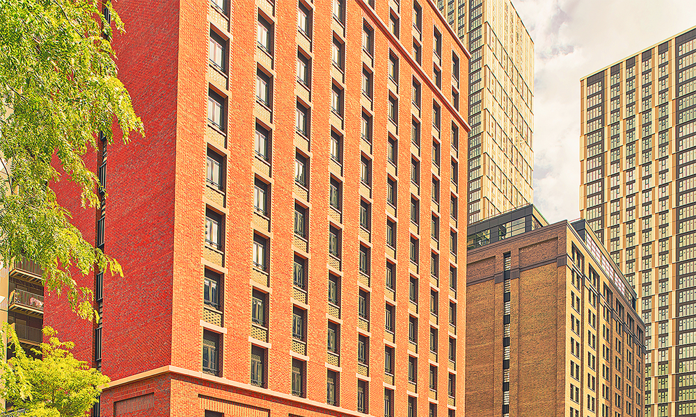 Image shows Vertus blocks at Wood Wharf, clad in brick in front of more residential towers