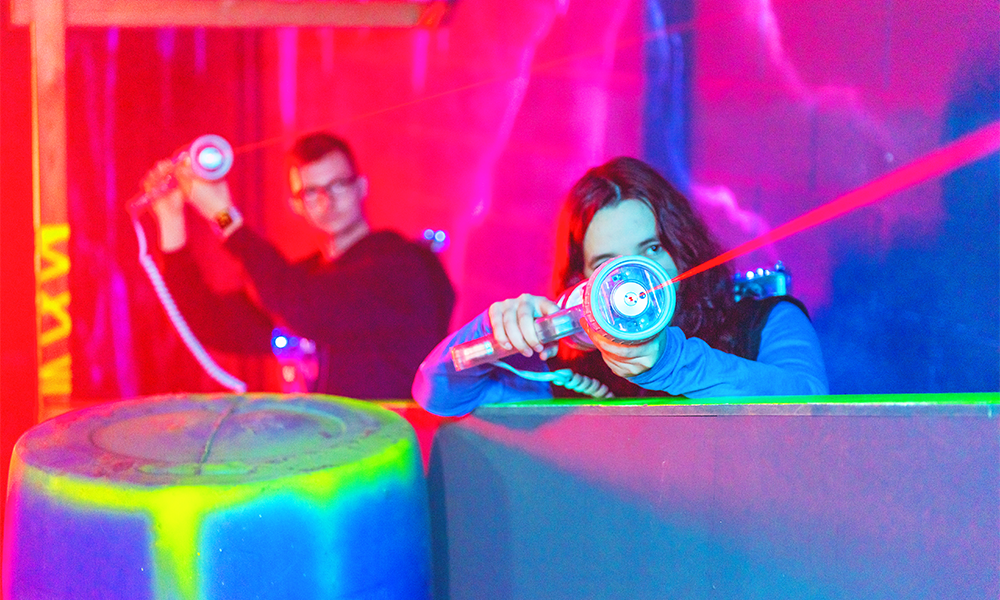 Image shows a man and a woman playing at Laser Quest Greenwich