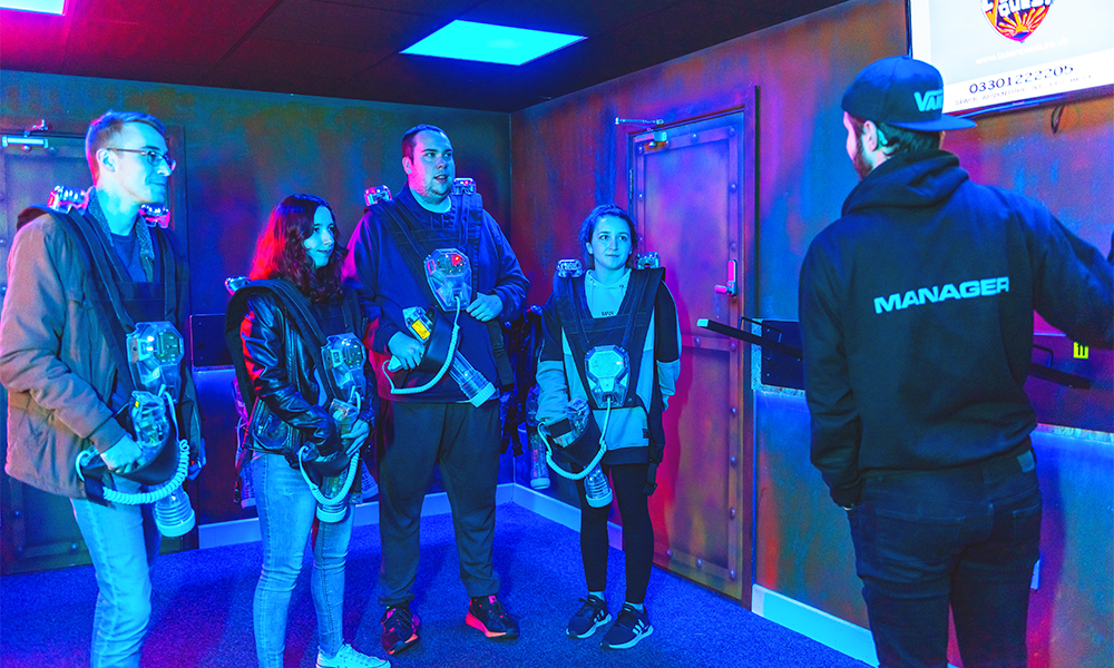 Image shows a Laser Quest Greenwich employee giving a briefing