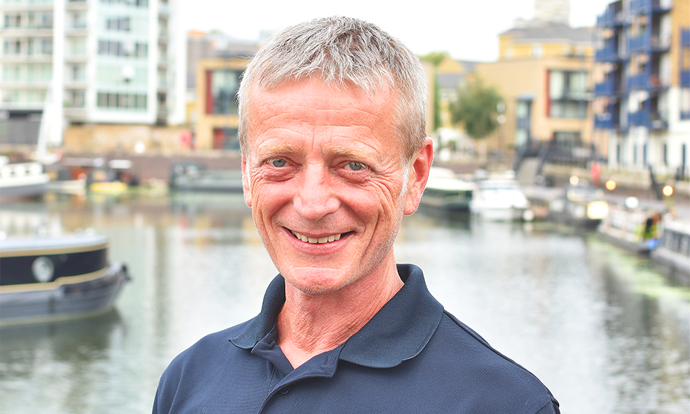 Image shows broker at Boat Sales By Aquavista, Richard Hogarth. A man with short grey hair wearing a blue polo shirt