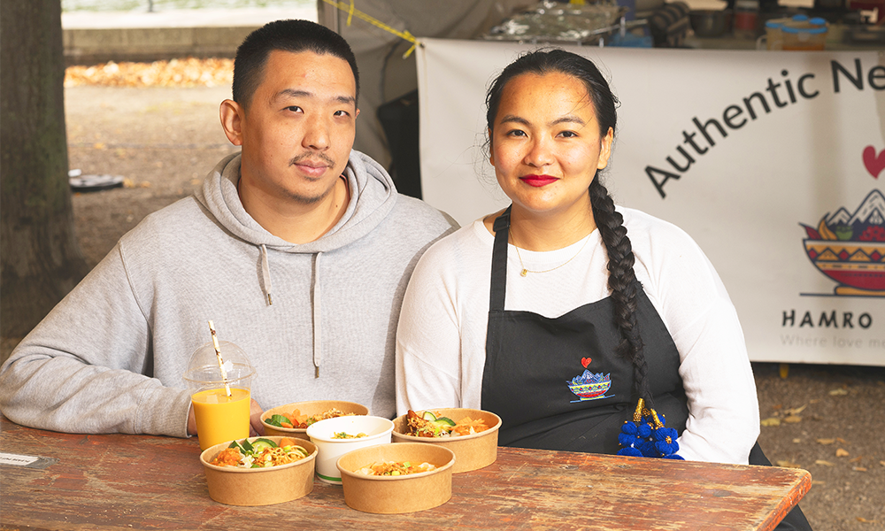 Image shows Kiyam Lin, left, and Laxmi Gurung of Hamro Maya – a man and woman wearing a grey hoodie and a white top and black apron, respectively