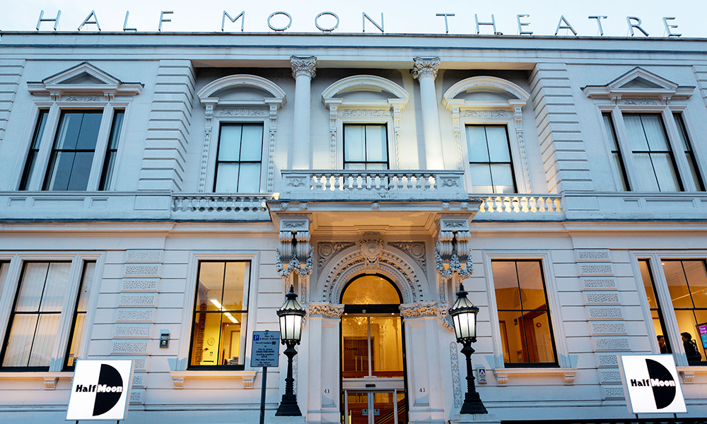 Image shows the outside of Half Moon Theatre, a white building in Limehouse