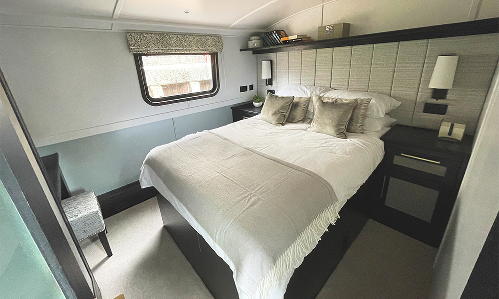 Image shows a bedroom aboard a house boat at Limehouse Marina