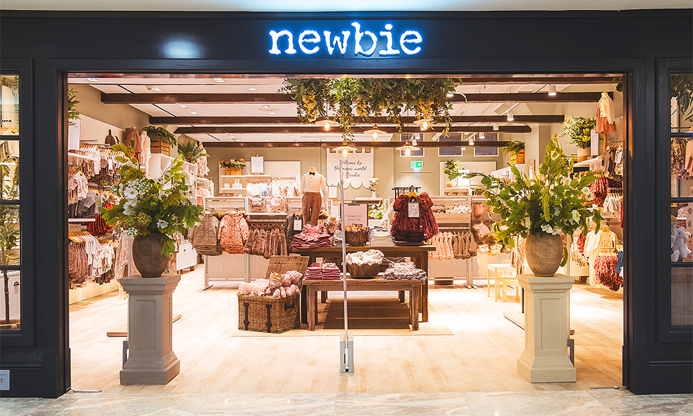 Image shows Newbie's dark grey store front and products within in Canary Wharf