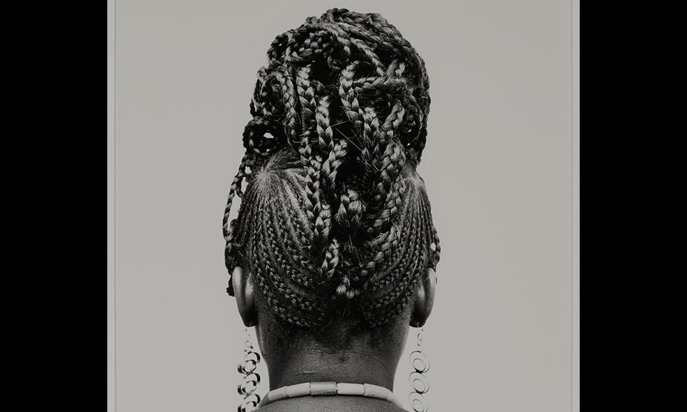 Image shows the back of a woman's head with braided hair in place