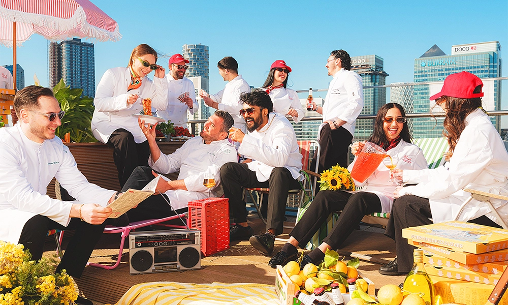 Members of the Barbarella team post at Bokan on the Isle Of Dogs. We're not sure, but it's unlikely Canary Wharf's towers will be decorated like this for the opening - image by Haydon Perrior / Big Mamma Group
