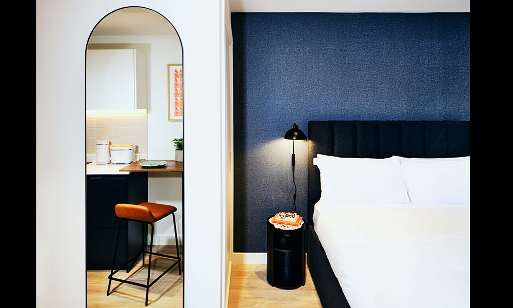 Rooms at the aparthotel are decorated in a cosy, minimal style - image by Vertus