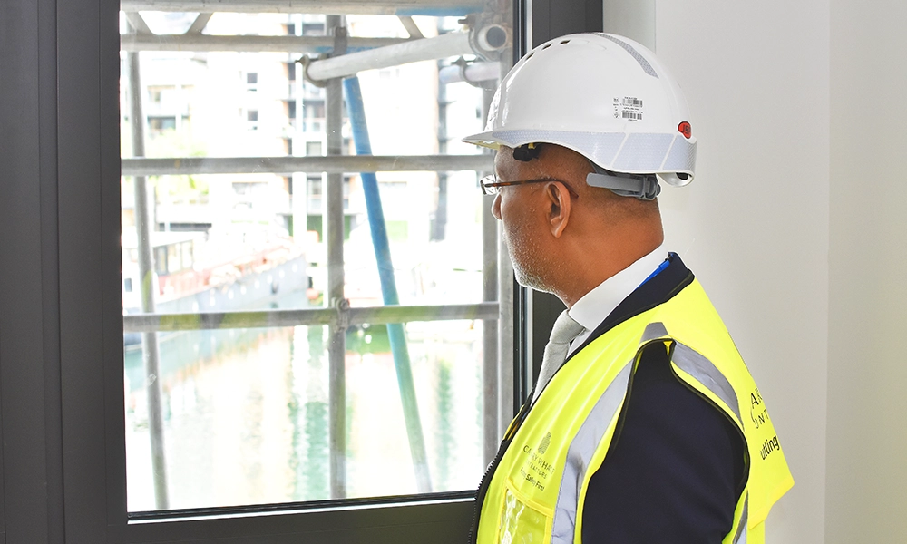 The Mayor surveys the view of Blackwall Basin from a property in Brannan Street - image by Jon Massey