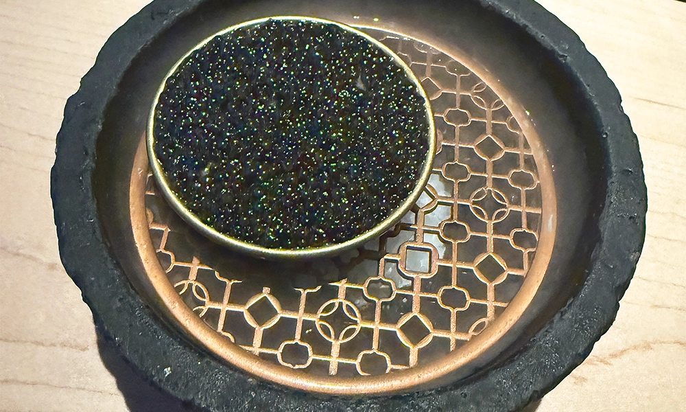 Caviar and tuna are served in a black orb with dry ice pouring out - image by Jon Massey / Wharf Life