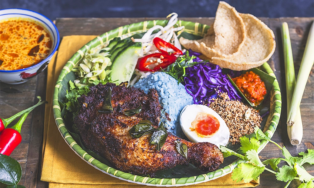 Ayam Goreng Berempah with the blue Nasi Kerabu, which gets its colour from the butterfly pea flower - image by Ong Lai Kopitiam 