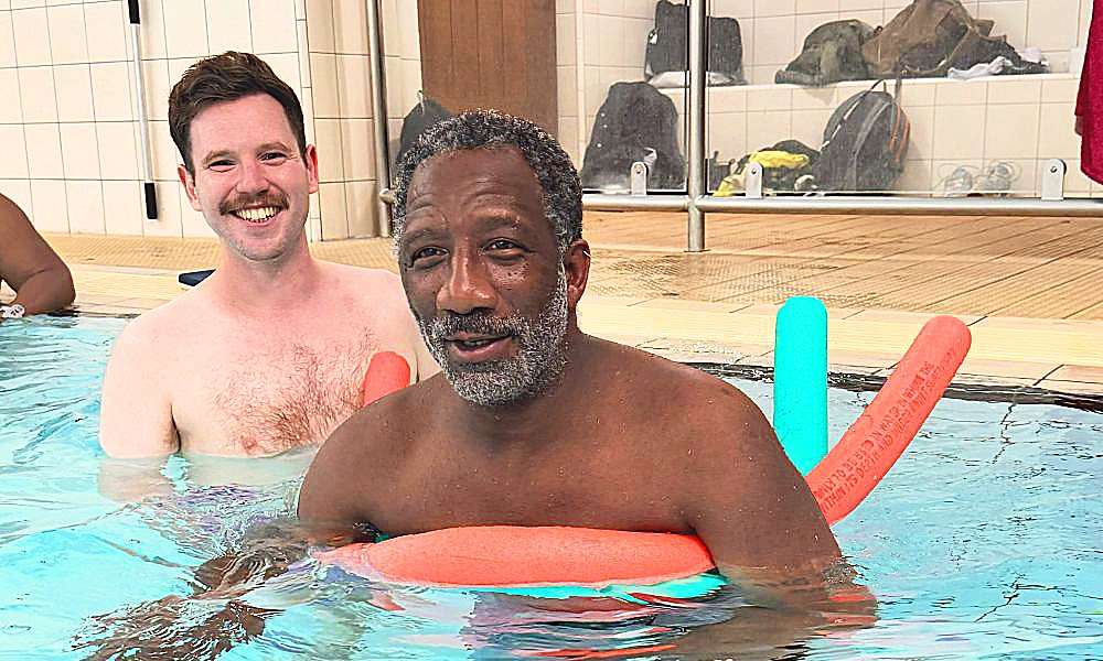 Volunteer Jack Cunningham, left, assist Eddie at a WeSwim session. Jack will be managing the Canada Water club - image by WeSwim