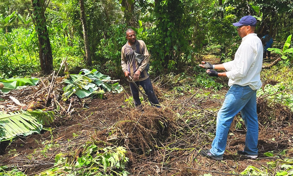 Daniel talks with a farmer in Cameroon - image by Amero