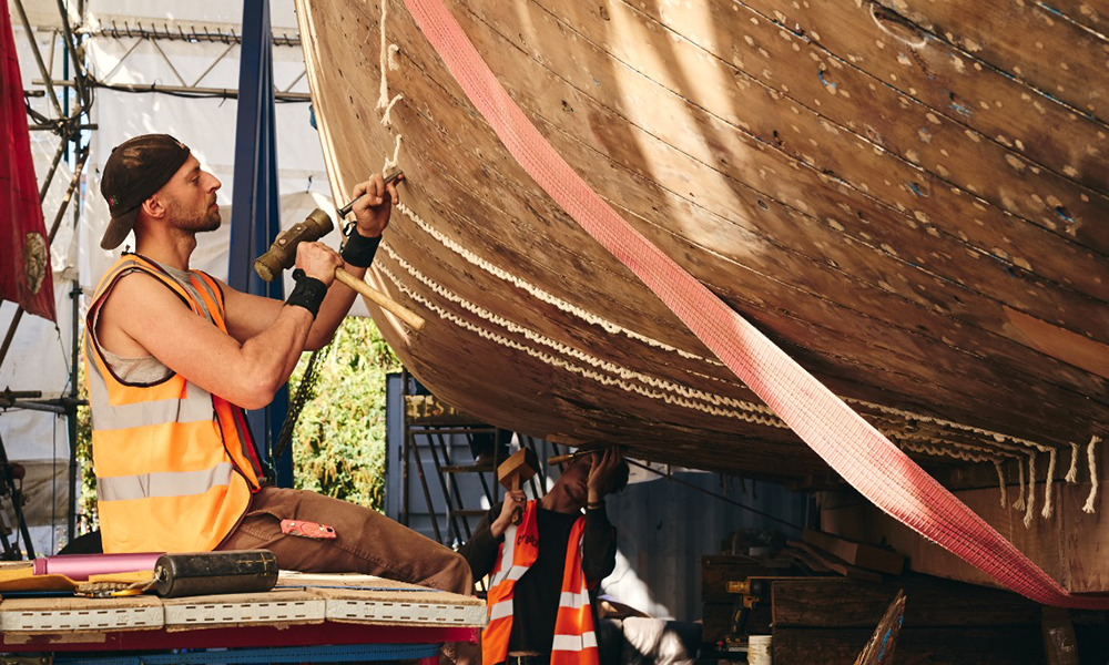 Ben works to create a watertight seal between the timbers - image by Ben Bradford
