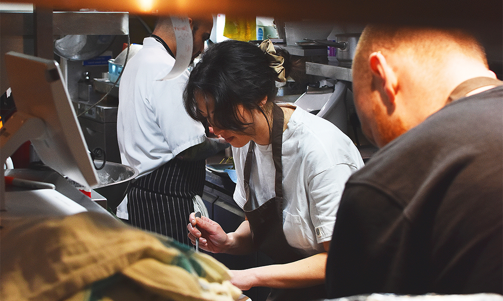 Barge East executive chef Kayla Dimmick and her team, hard at work in the floating venue's kitchen - image by Jon Massey / Wharf Life