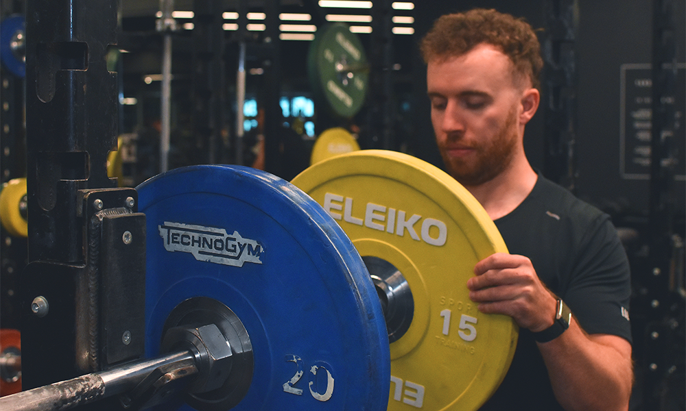 Will loads up a bar on one of the club's squat racks - image by Jon Massey / Wharf Life